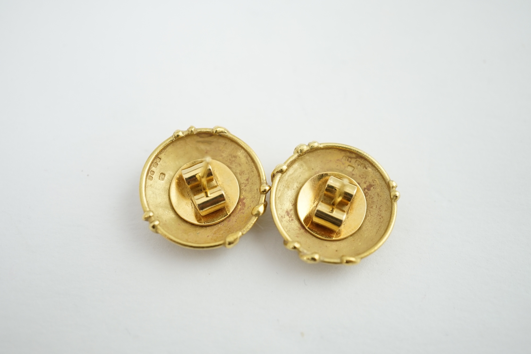 A pair of 18ct yellow gold circular dome stud earrings, each set with three graduated diamonds within a twisted branch design, hallmark London 1974, and matted ground